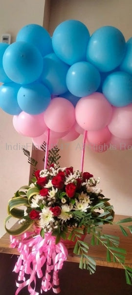 Pink and blue balloons bundle 25 in number on the sticks of a basket in a bundle or cluster filled with orange and red flowers (Size of arrangement 3 to 4 feet) I-AFBO