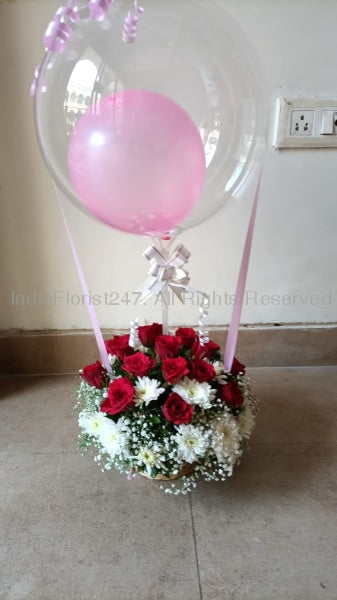 It's a Girl Balloon Bouquet - Single pink balloon in a clear bubble balloon tied to a 10 red and white roses basket C-BFST