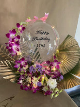 Load image into Gallery viewer, Print text with happy anniversary on clear balloon with orchid trailing on the balloon perched on top of pink roses with Gold colour leaves C-BFST
