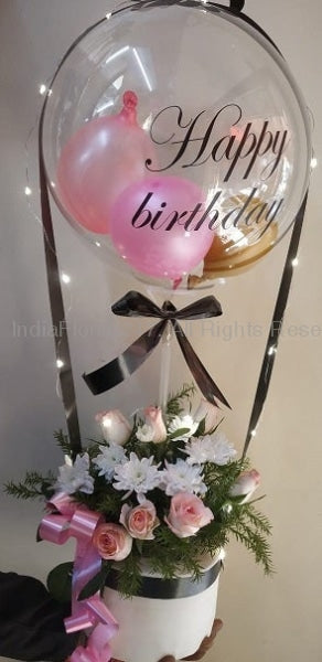 With printed text Happy birthday on the transparent balloon with small pink and black balloons stuffed inside in a box of 10 pink roses beads string and string lights black ribbons C-BFST